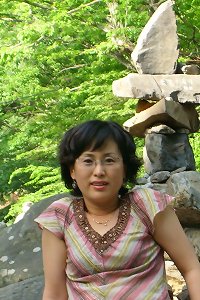 asian lady in swimsuit laying down on a bed